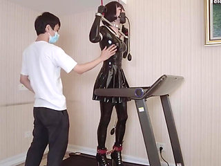 Mz24 - a Girl Bound to a Treadmill with Metal Restraints and Shackles
