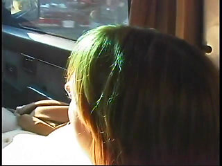 Commuter redhead carpools with creep who debases her in car in city traffic