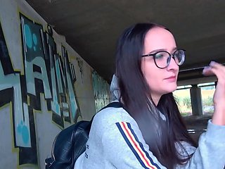Glasses girl strokes that dick and takes it under the bridge