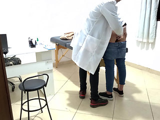 Proctologist performs anal exam on constipated patient.