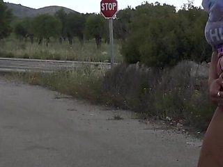 Short hair blonde babe enjoys pissing outdoors