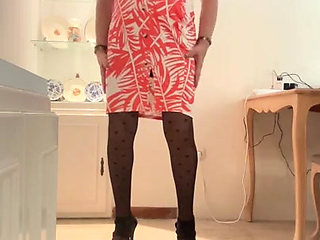 Beautiful and horny Spanish trans girl with long legs cums in an orange dress, skirt and top, black heels, and lingerie